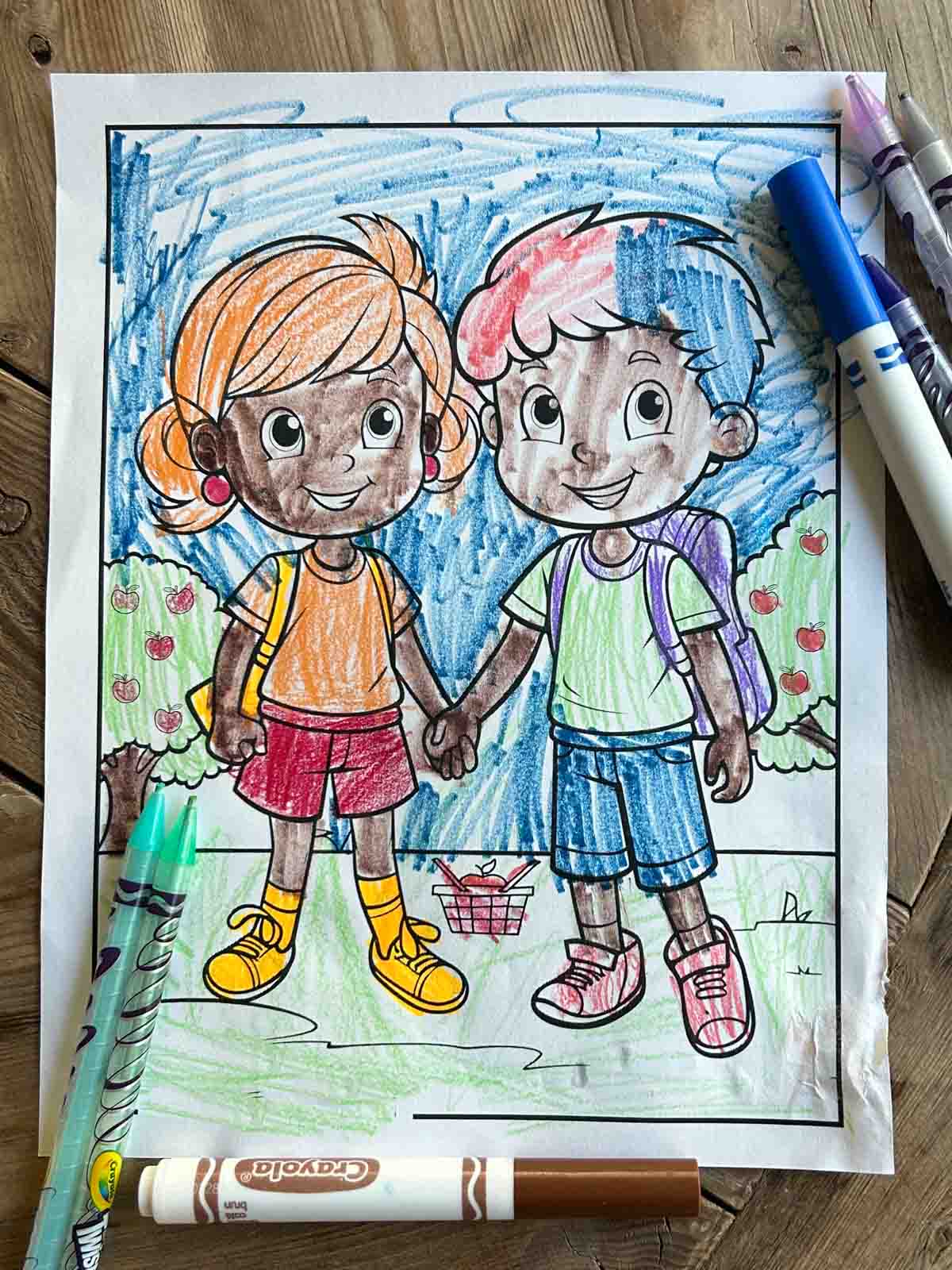 Two best friends coloring sheet colored using crayons.
