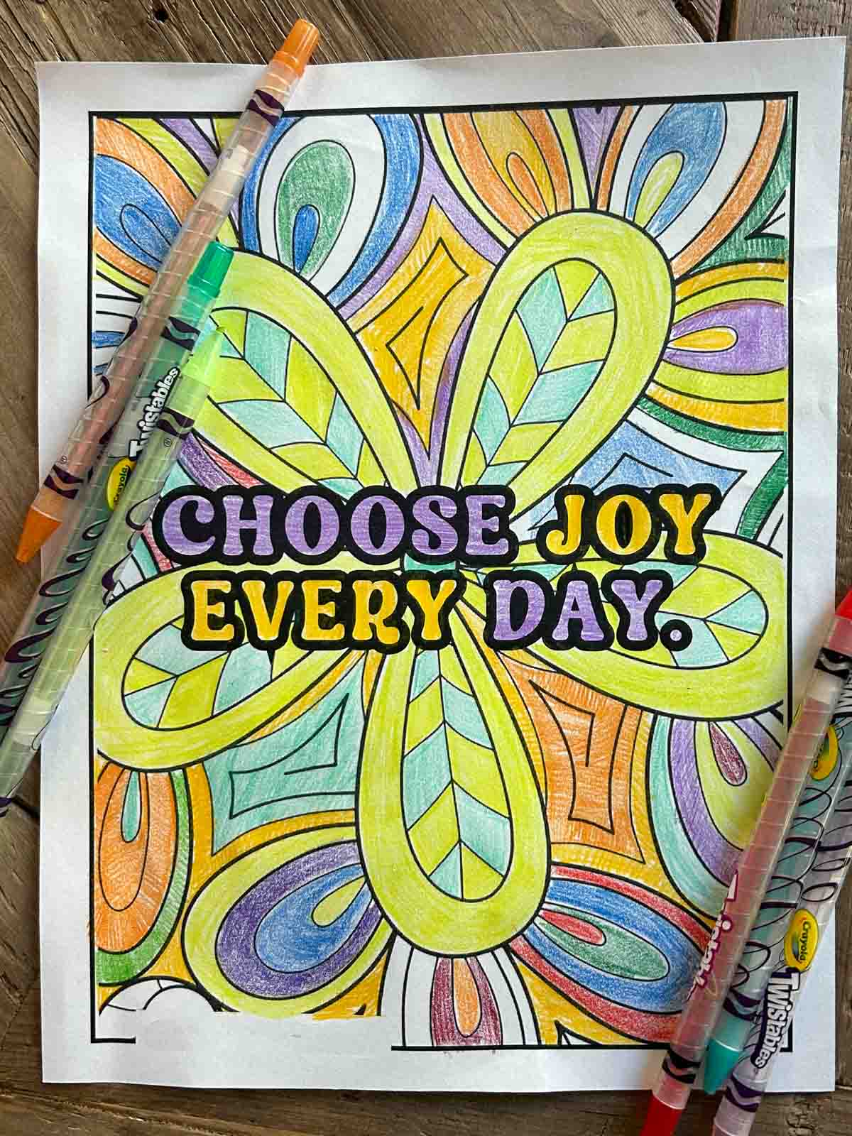 A completed quote coloring page colored using crayons.