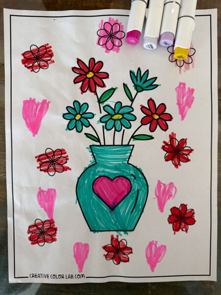 Finished flower coloring page using colored pens.