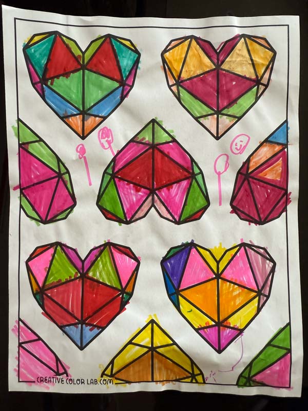 A valentines day coloring page shaded by a kid.