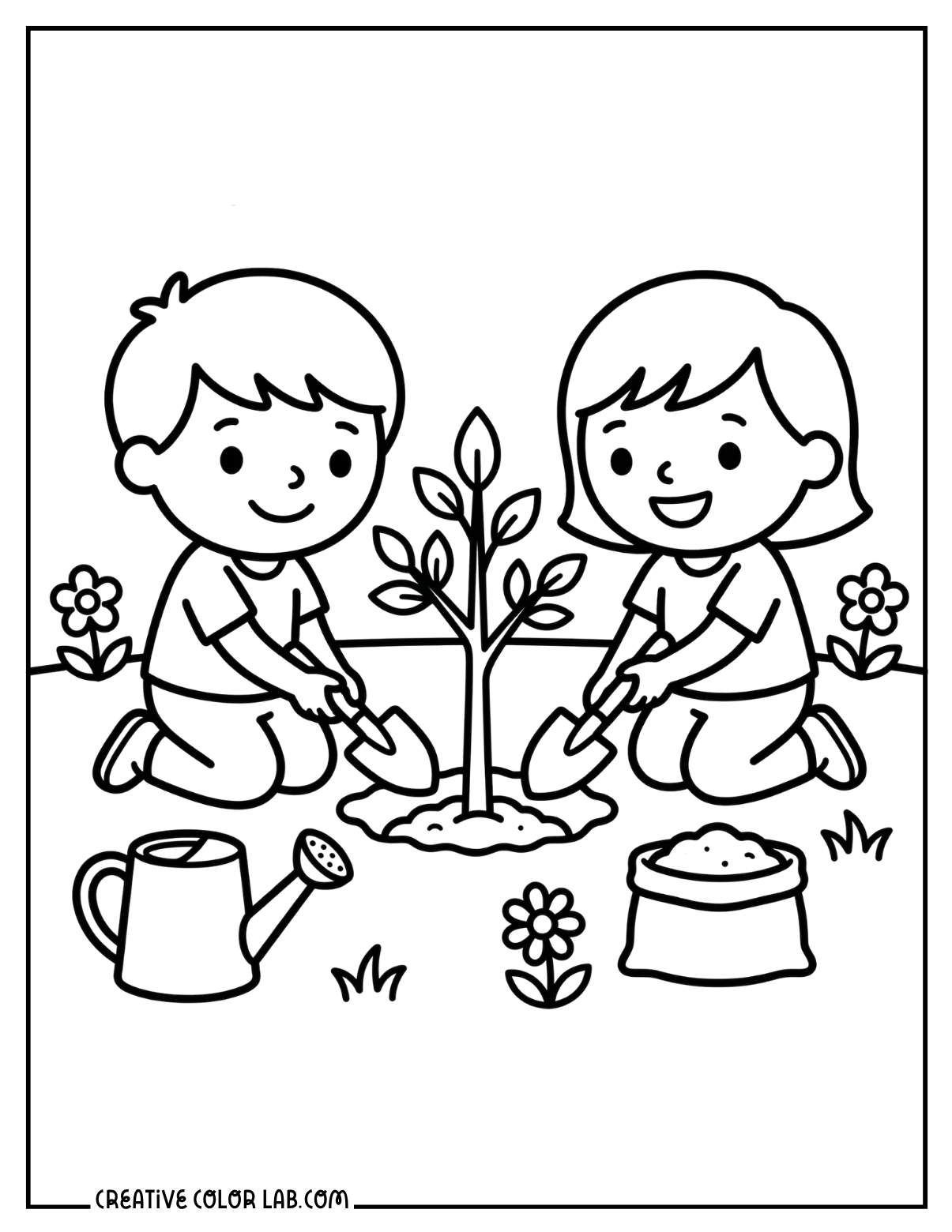 Two children kneeling together to plant a small tree for Earth Day, with flowers nearby.